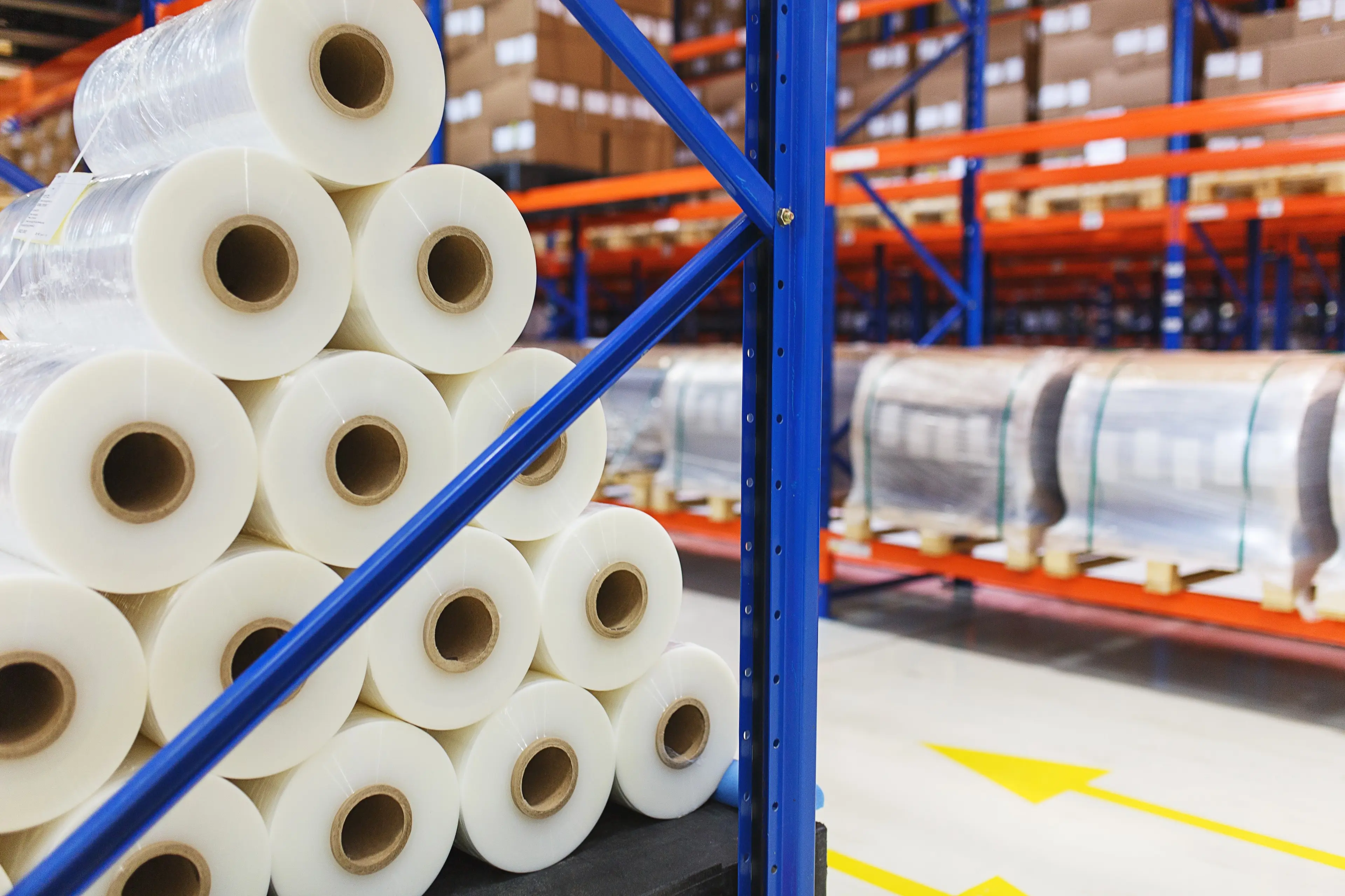 Rolls of polyethylene film on shelving in warehouse