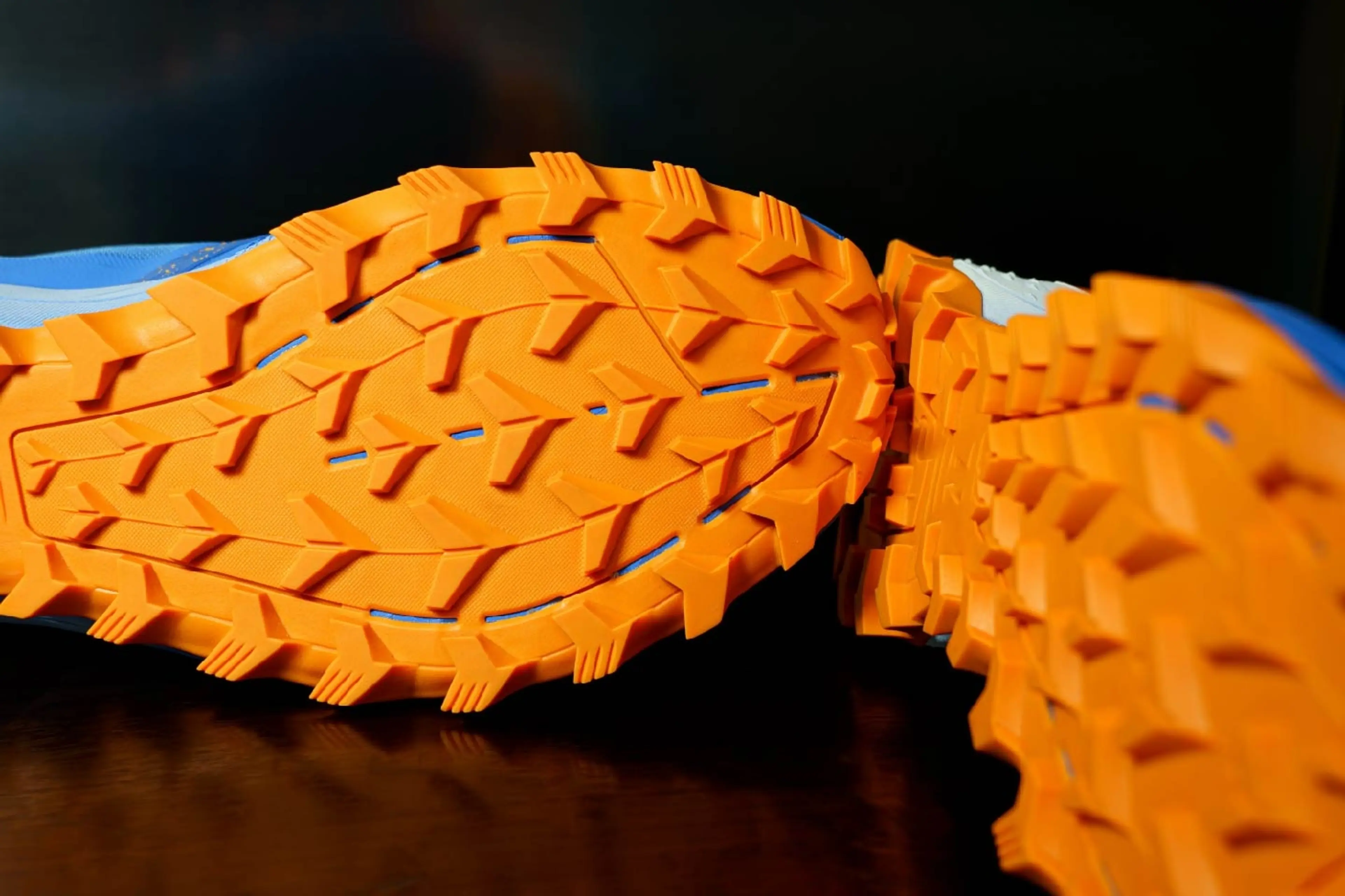 Sports Shows with orange tread soles for trail running